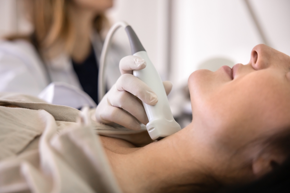 Hand,Of,Female,Doctor,Doing,Sonogram,Of,Thyroid,,Examining,Patients